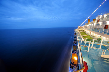 Fototapeta cruise ship floats at night, long exposure obraz