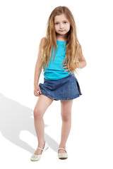 Little girl poses for camera  with one foot on the toe