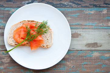 Smoked salmon on sourdough bread garnished with fresh dill.