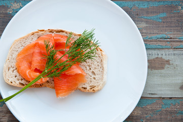 Smoked salmon on sourdough bread garnished with fresh dill.