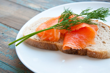 Smoked salmon on sourdough bread garnished with fresh dill.