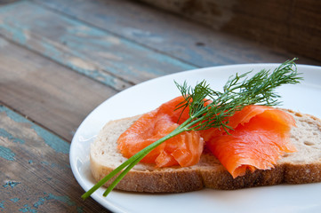 Smoked salmon on sourdough bread garnished with fresh dill.