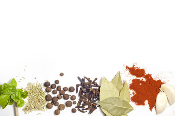 Herbs and spices border on white background