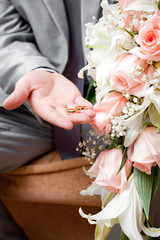 Gold wedding rings on a hand of the groom