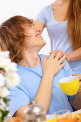 Young happy man drinking tea