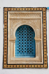 Window with islamic arch in a white tunisian building