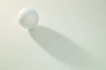 golf ball on white with light and shadow