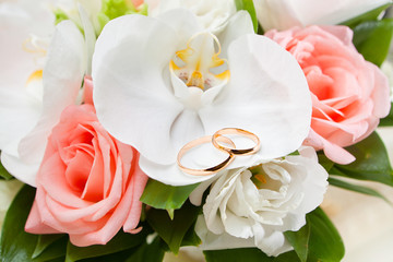 Gold wedding rings on flower
