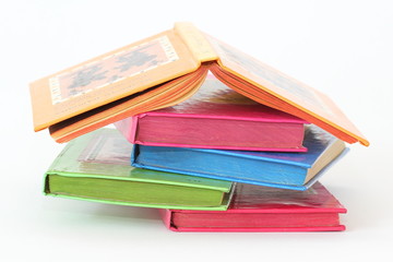 stack of bright books over white