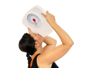 young woman kisses a weight scale