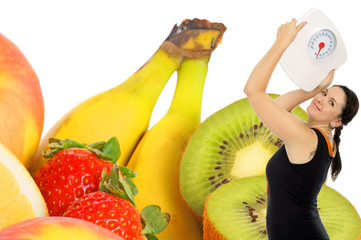 young woman with a weight scale and fresh fruit