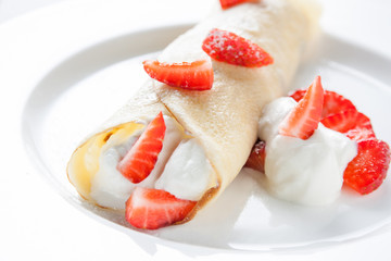 Crepe with cream and fresh strawberries