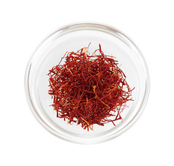 stigmas of saffron in transparent bowl isolated