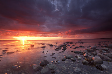 Sunrise over ocean, stormclouds approaching