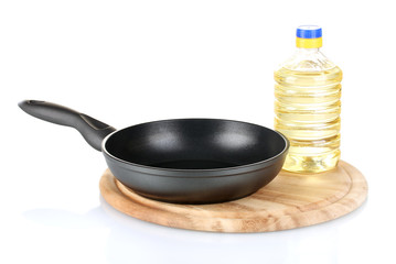 Pan with bottle of oil isolated on white