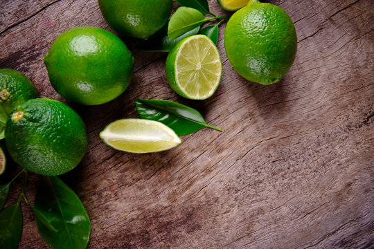 Fresh limes on wooden background