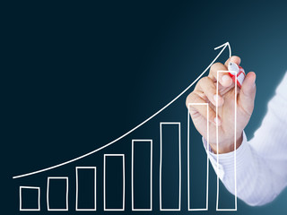 Businessman drawing a growth graph
