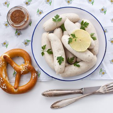 White sausages with sweet mustard and pretzel