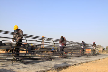 reinforced component at the construction site and workers