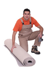 handyman with a carpet roll
