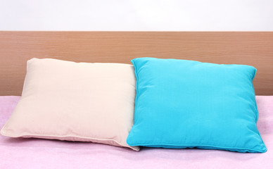 Fototapeta na wymiar bright pillows on bed on white background