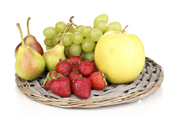 ripe sweet fruits and berries on wicker mat isolated on white