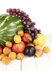 Still life of fruit on wooden table isolated on white