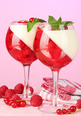 fruit jelly with berries in glasses on pink background