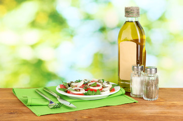 Salad with capers in the plate on bright green background
