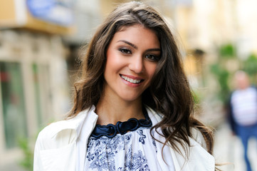 Beautiful woman smiling in urban background