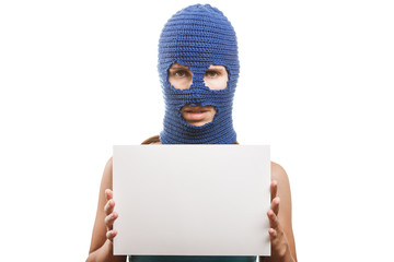 Woman in balaclava holding blank card