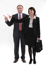 Mature businesspeople standing on white background