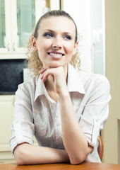 Young smiling blond woman thinking