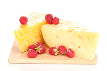 tasty cheese and berries on wooden board isolated on white