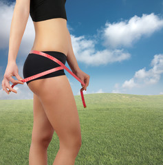 Girl measuring her belly after diet
