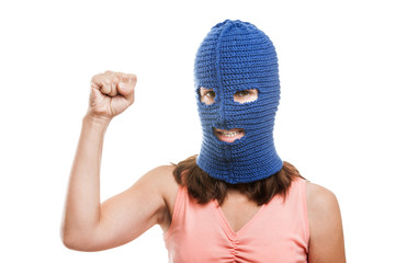 Woman in balaclava showing raised fist gesture