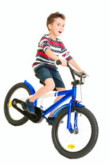 Happy naughty little boy riding bike
