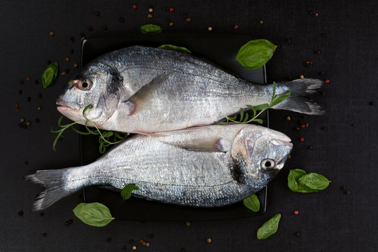 Two Fish On Black Plate, Top View.