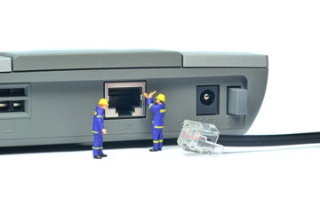 Engineers repairing LAN internet connection on a router