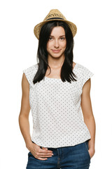 Young trendy female wearing jeans and straw hat