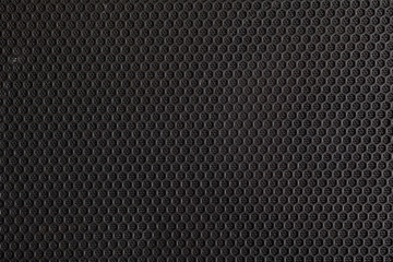 Black speaker grill, metal background, abstract texture.