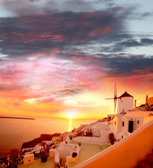 Santorini with windmill against sunset in Greece