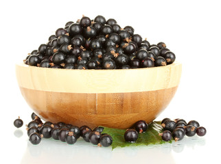 Fresh black currant in wooden bowl isolated on white