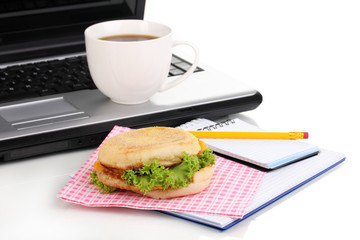 Eating at work place near laptop