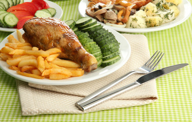 Roast chicken with french fries and  vegetables,