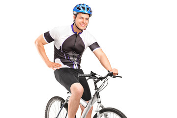 Male biker with helmet posing on a bike