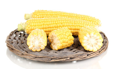 Fresh corn on wicker mat isolated on white