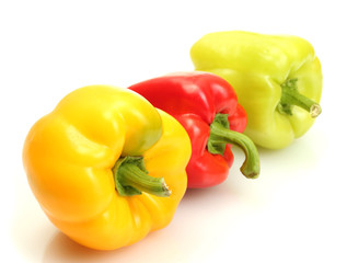 fresh yellow, red and green bell peppers isolated on white