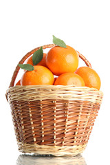 tangerines with leaves in a beautiful basket isolated on white