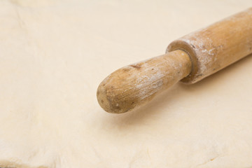 the dough with a rolling pin as a background